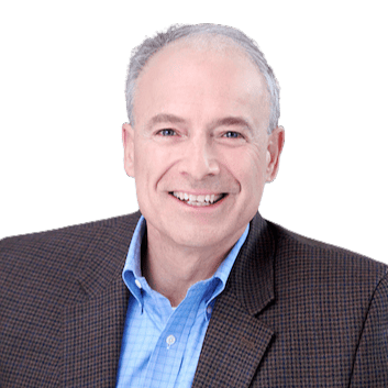 Portrait of a smiling middle-aged man in a blue shirt and brown blazer.